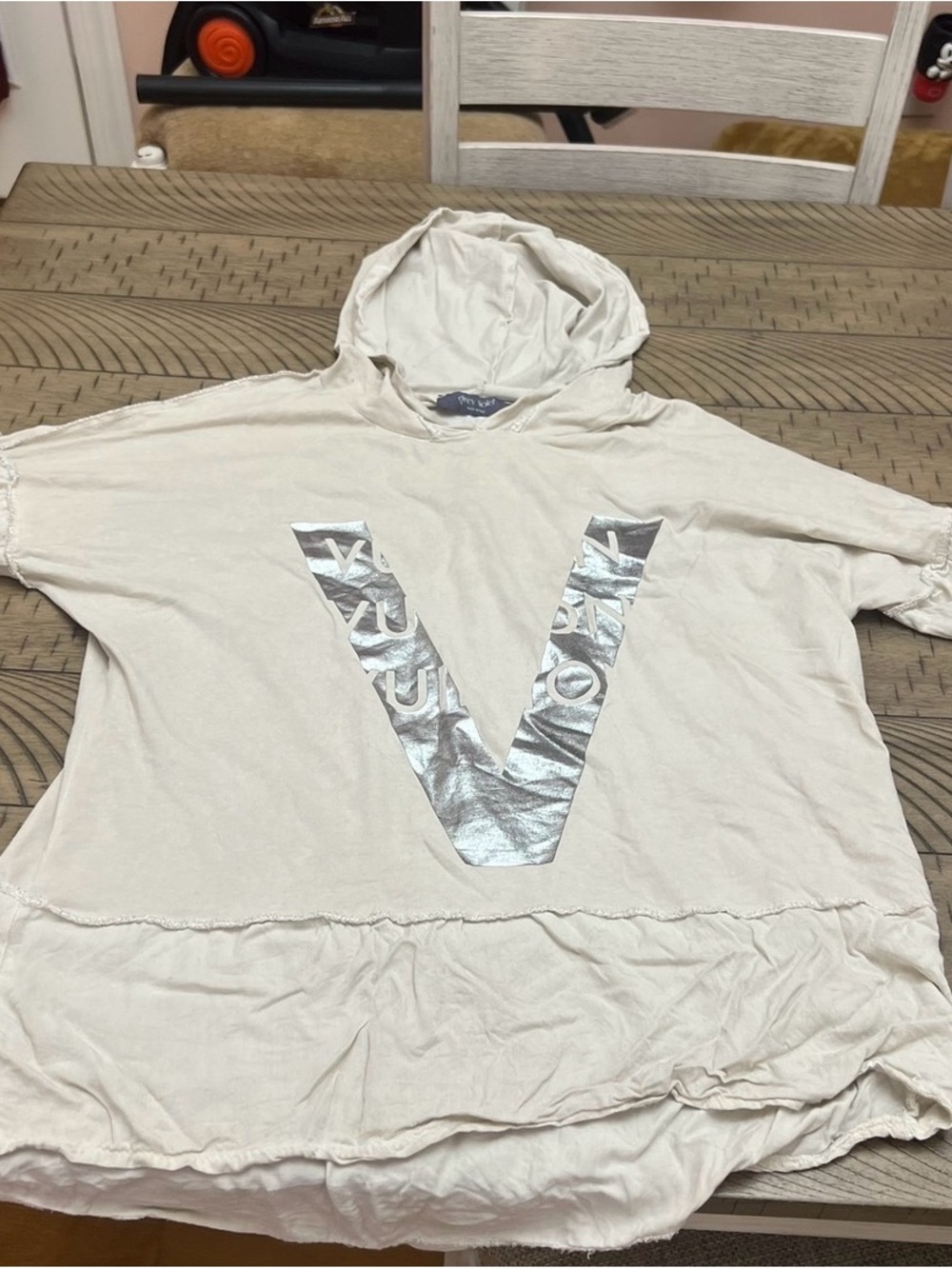 Women’s Hooded shirt with Silver V Accent bought at a boutique.. Size Medium.